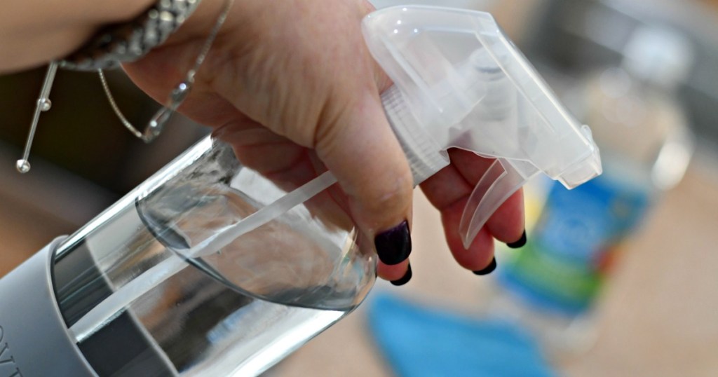hand holding squirt bottle full of water