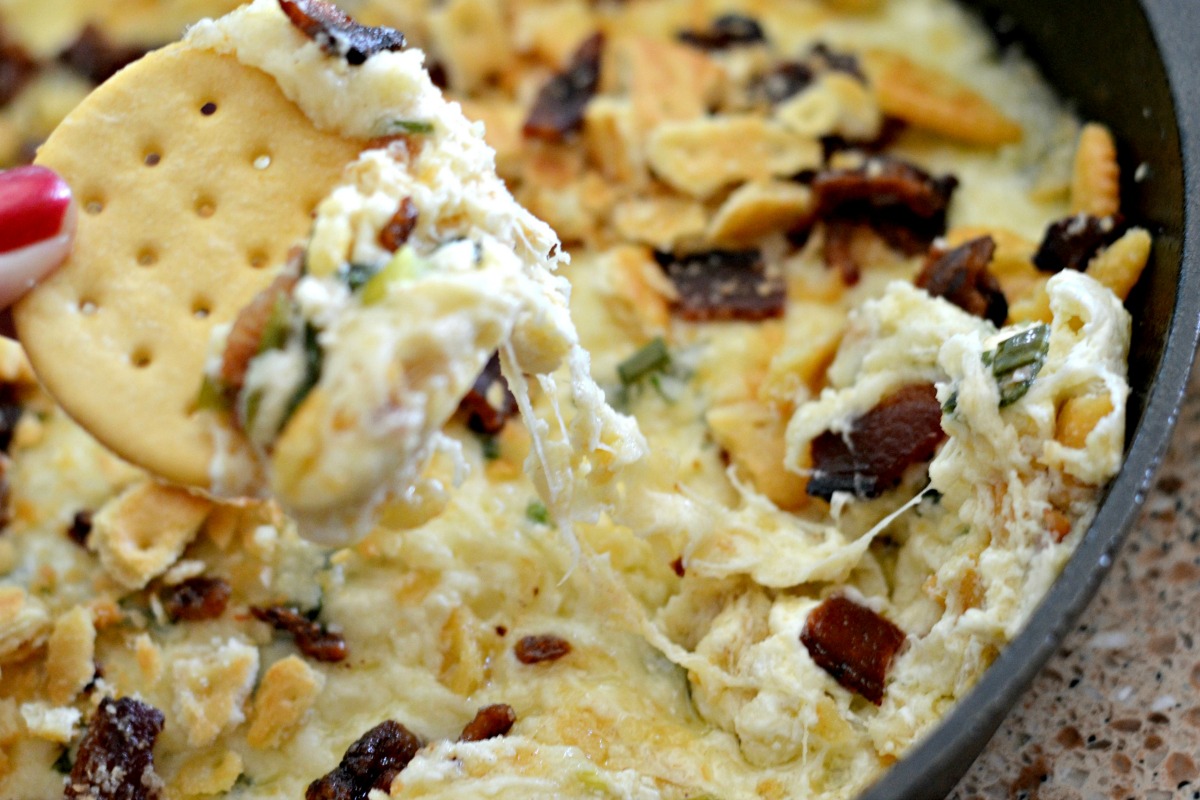 6-ingredient Swiss cheese bacon dip &ndash; dipping a cracker in the dip