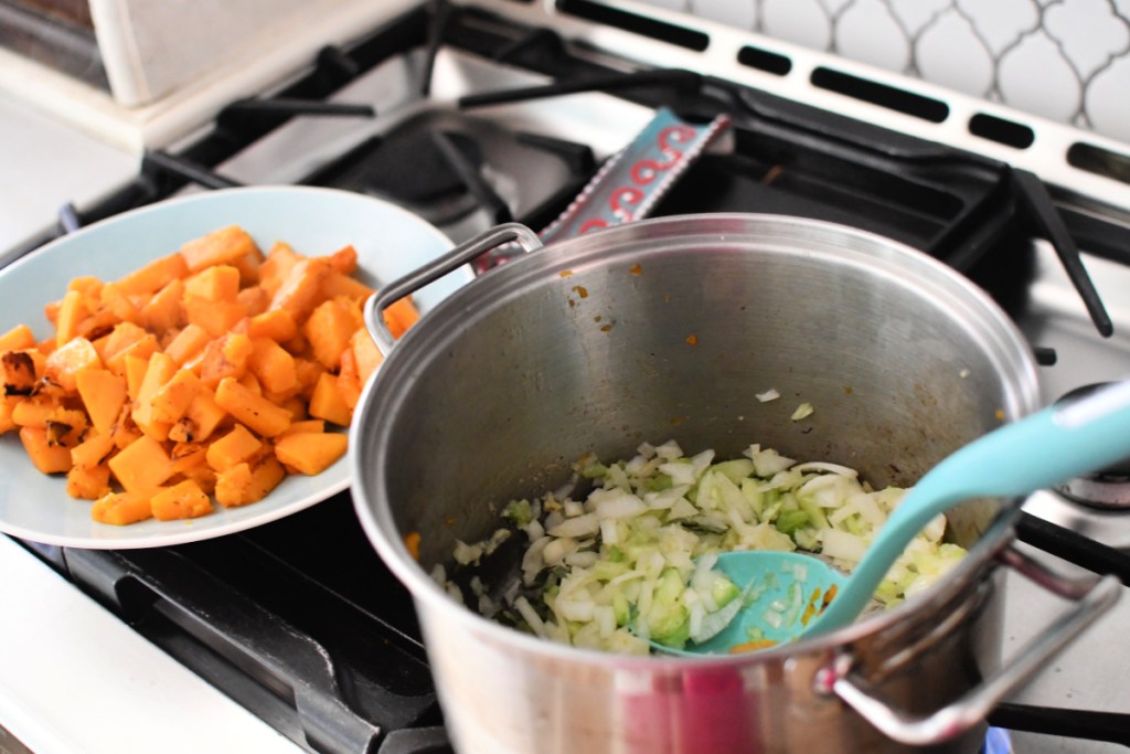 saut&eacute;ing veggies in a stockpot for butternut squash soup recipe