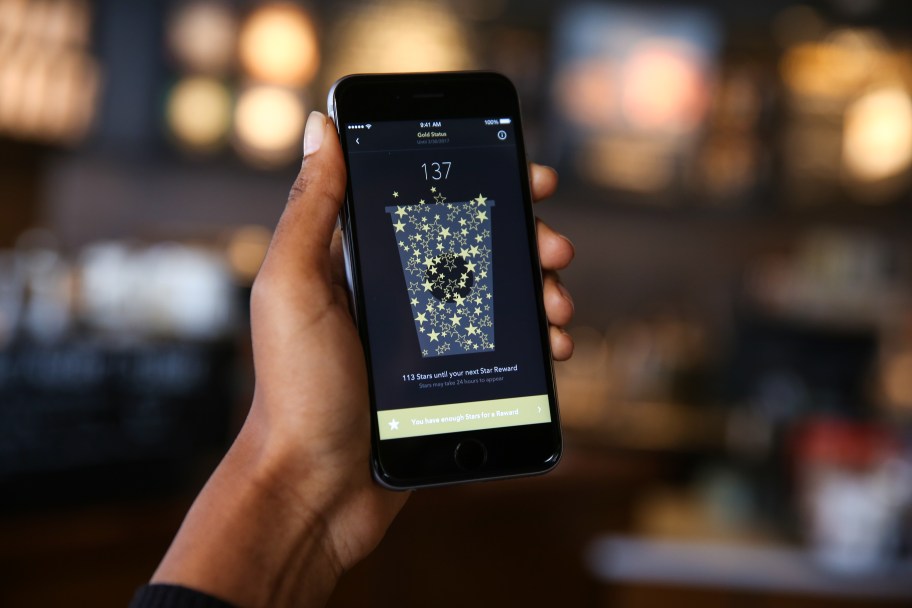 hand holding phone with starbucks app displayed