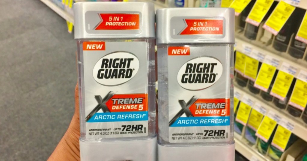 hand holding two deodorants 