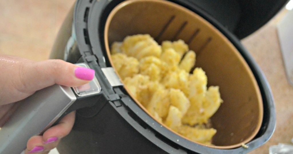 pulling out air fryer bloomin' onion 