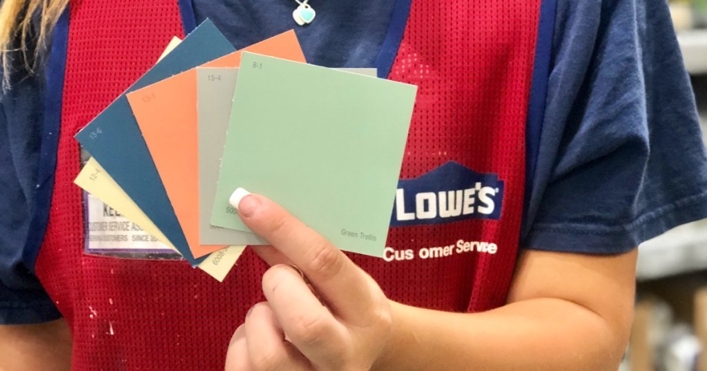 woman at Lowe's holding paint samples