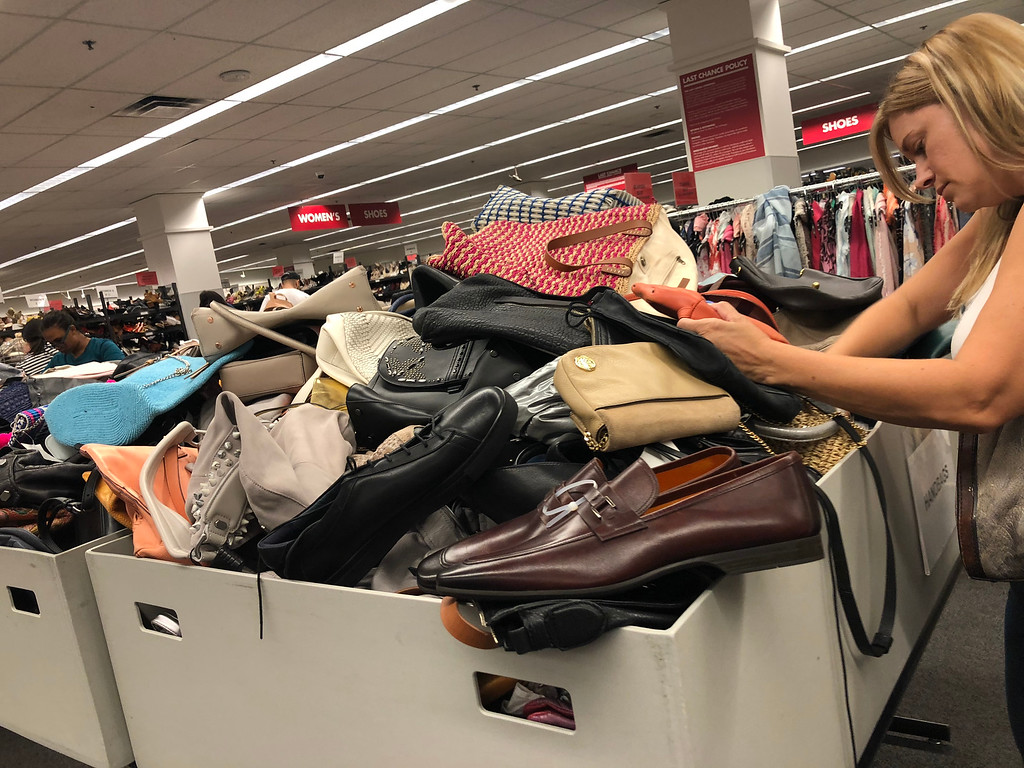  nordstroms last-chance store deals, tips, and tricks &ndash; woman searching in a bin