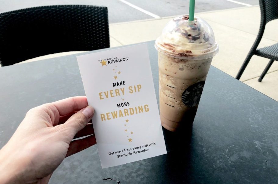 hand holding starbucks rewards sign