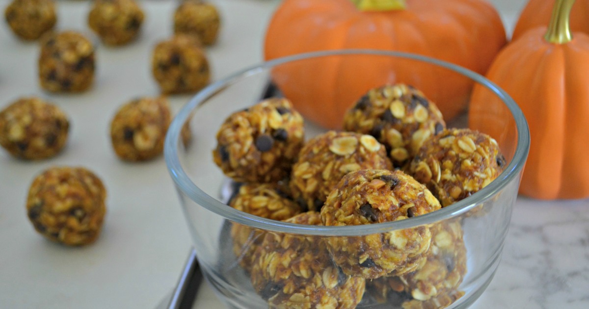 Pumpkin chocolate chip Oatmeal Cookie Dough Energy Bites &ndash; in a bowl next to pumpkins