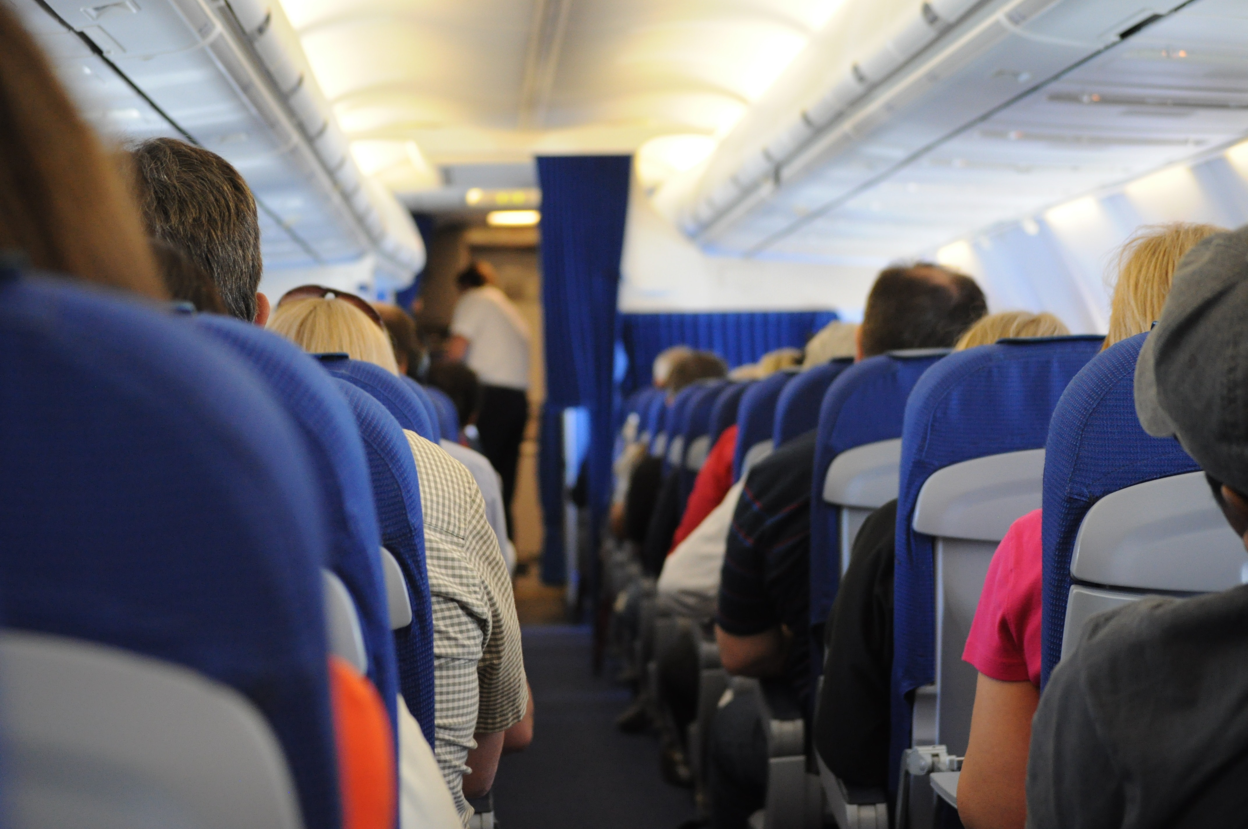 domestic airlines lawsuit settlement &ndash; passengers on an airplane