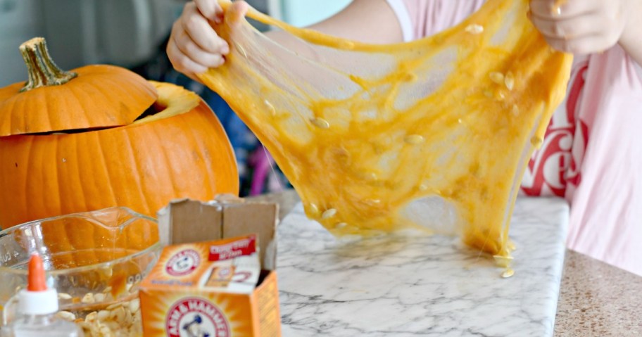 DIY Pumpkin Guts Slime &ndash; the slime being pulled apart