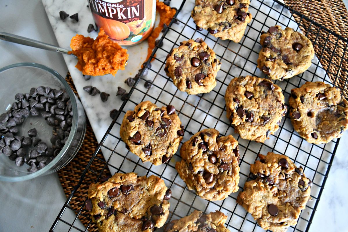 Pumpkin Chocolate Chip Cookies &ndash; on a cooling rack with pumpkin and chocolate chips nearby
