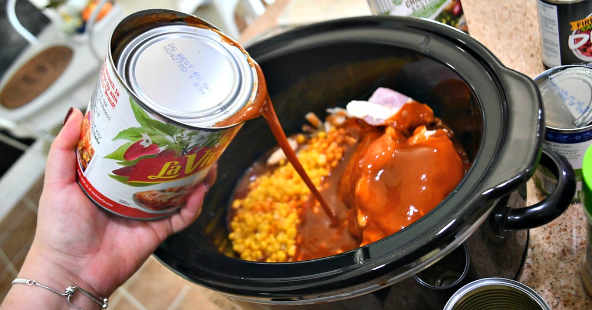 Slow Cooker Chicken Enchilada Soup &ndash; pouring enchilada sauce into the slow cooker