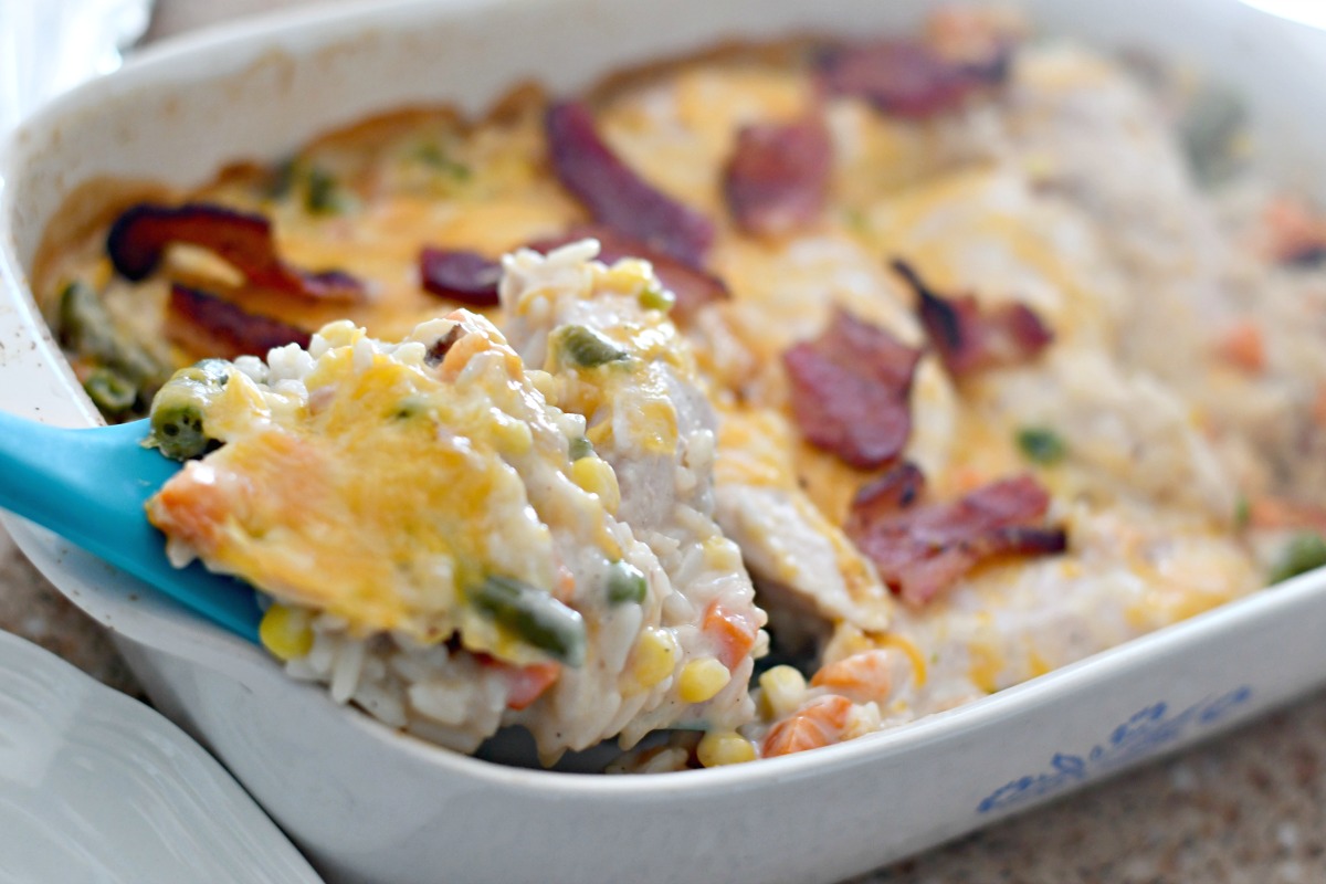 Cheesy Chicken Bacon and Rice Casserole &ndash; close up of the finished casserole being served with a spatula
