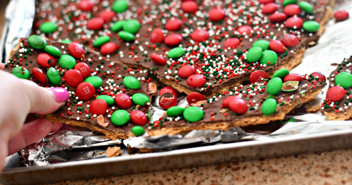 homemade christmas crack toffee &ndash; closeup of the toffee being broken apart in the pan