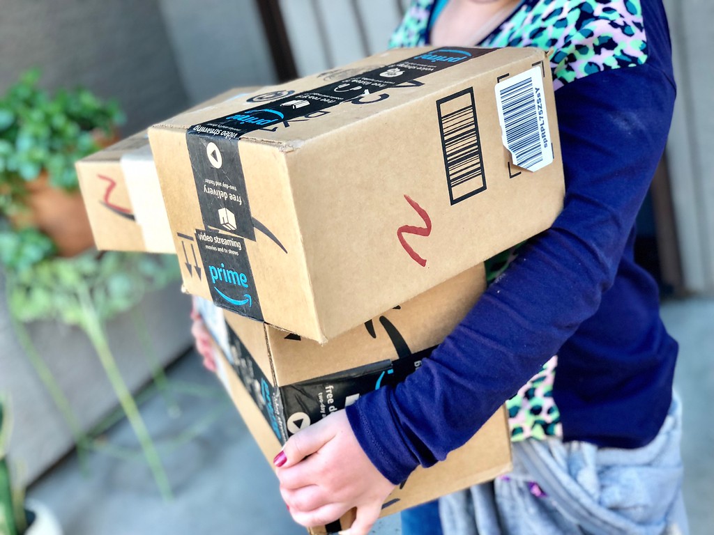Amazon Prime boxes in Collin's arms