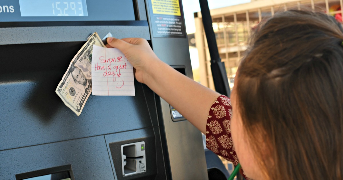 girl sticking money to a gas tank random acts of kindness