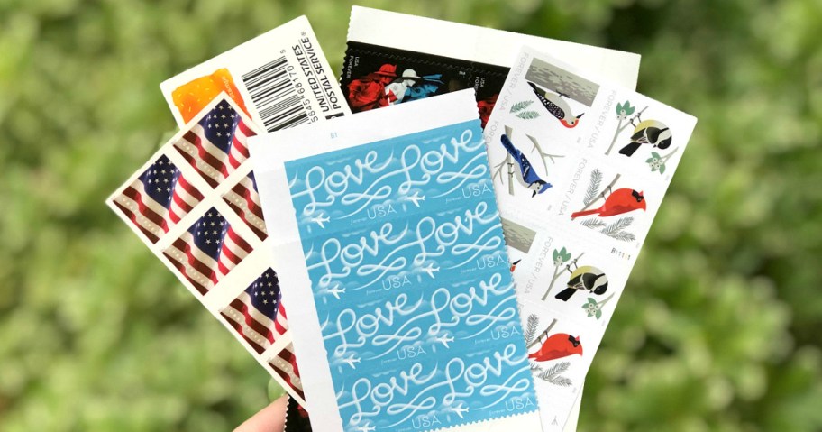 hand holding forever stamps 
