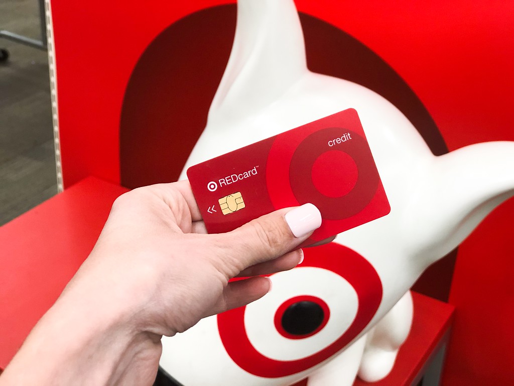 woman holding target red card in front of target dog