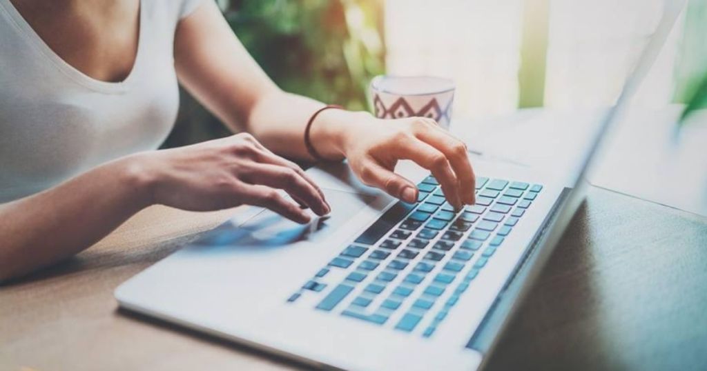 woman typing on a computer