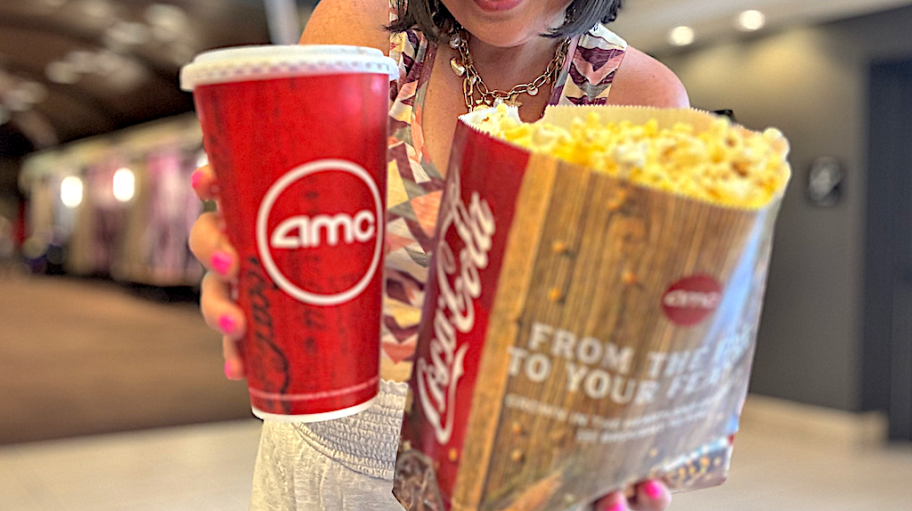 lina holding a drink and popcorn in a movie theatre