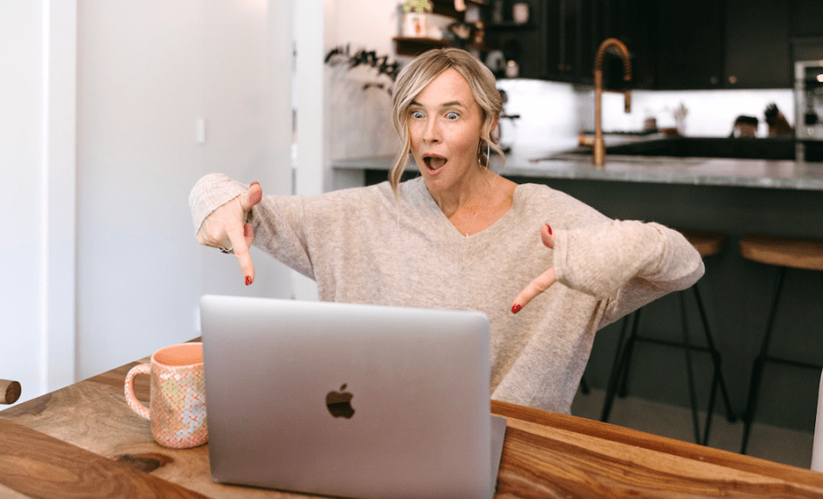 woman pointing to her MacBook