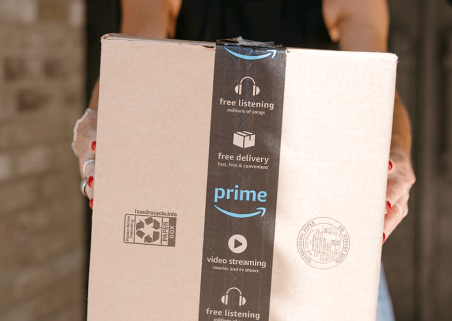 person holding an Amazon shipping box