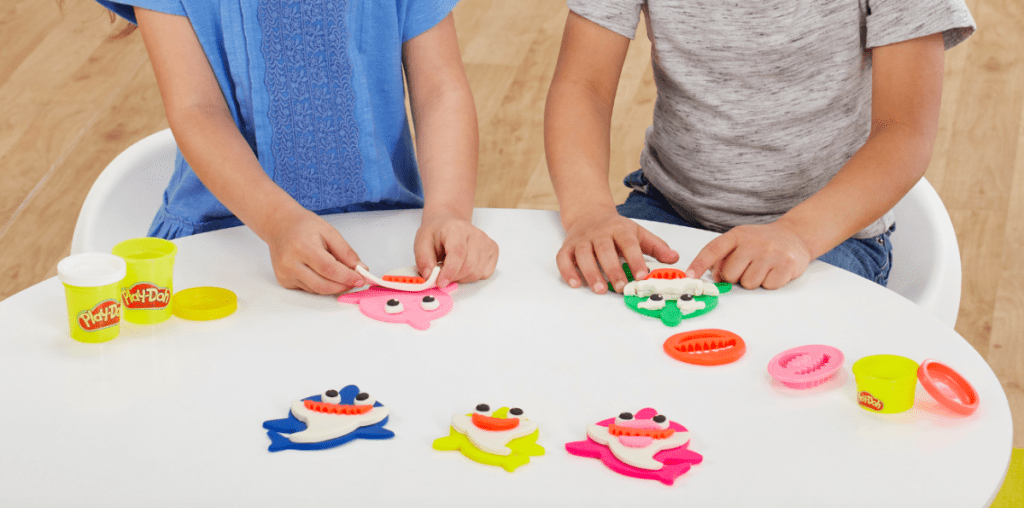 kids using cookie cutters to play at table