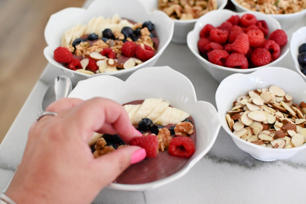 adding toppings to acai
