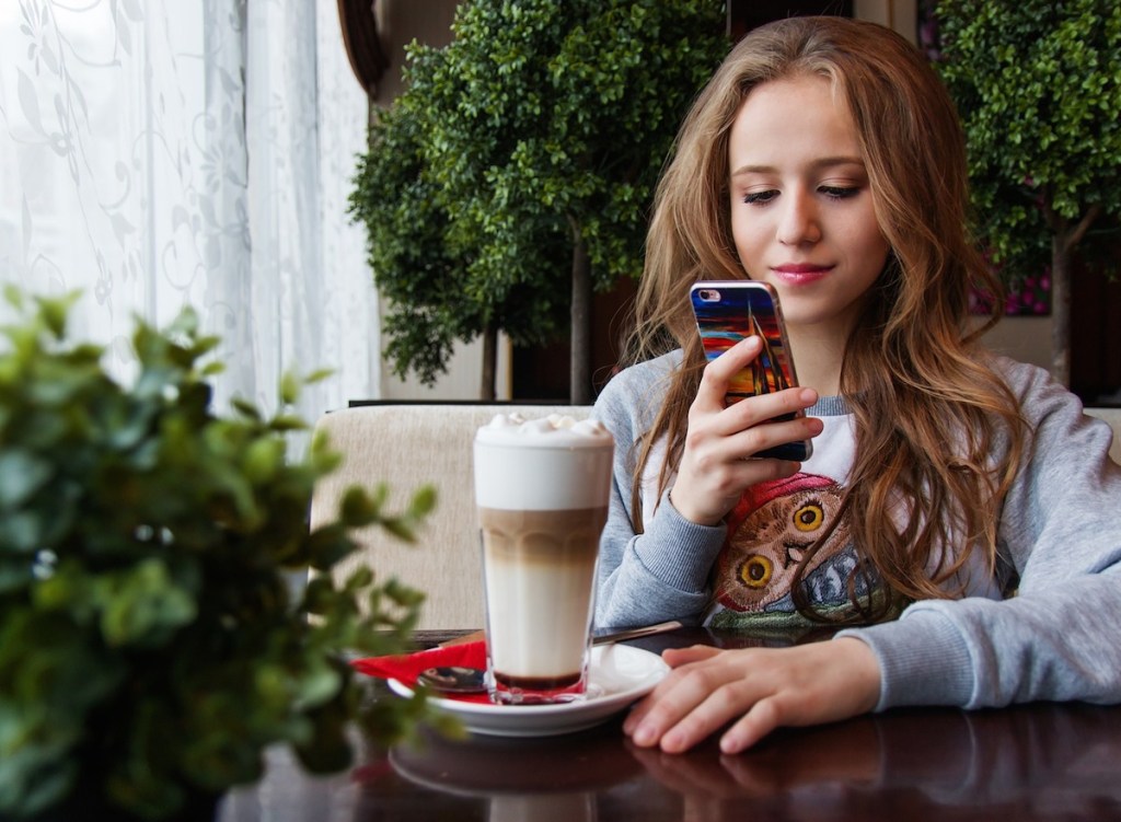 teenager girl looking at cell phone 