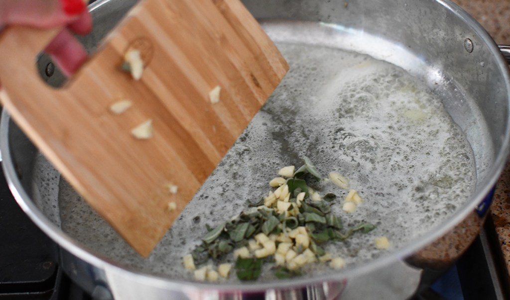 saut&eacute;ing garlic for pumpkin fettuccine alfredo