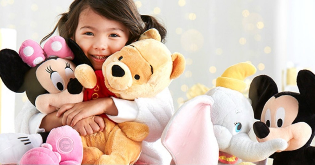 girl holding disney dolls