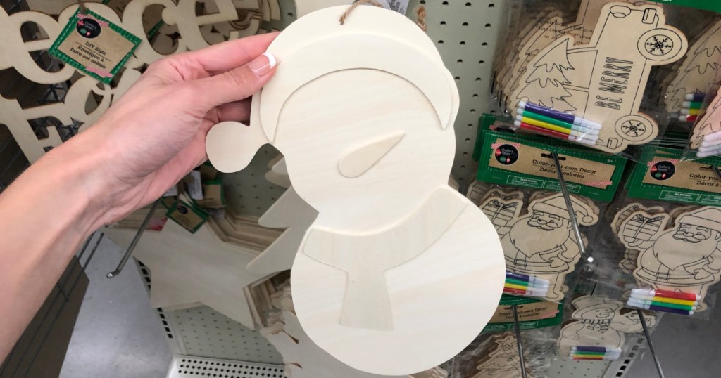 hand holding up wooden snowman