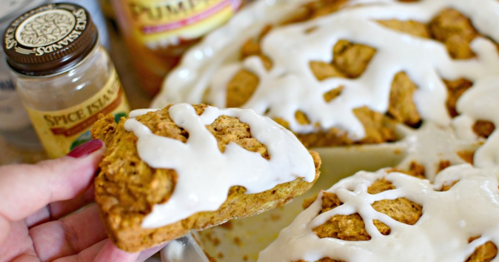 holding a pumpkin spice scone