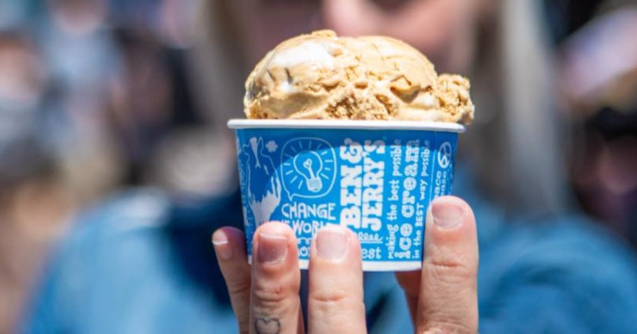 hand holding a scoop of ice cream in ben & jerry's cup