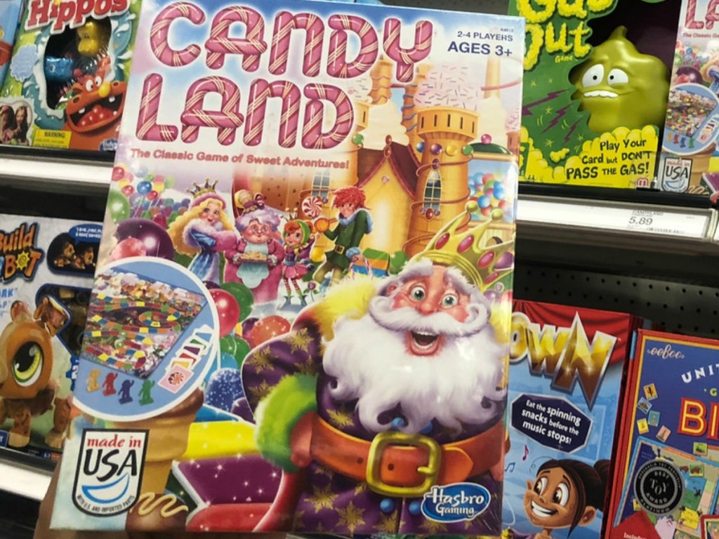 hand holding game of candy land by store display