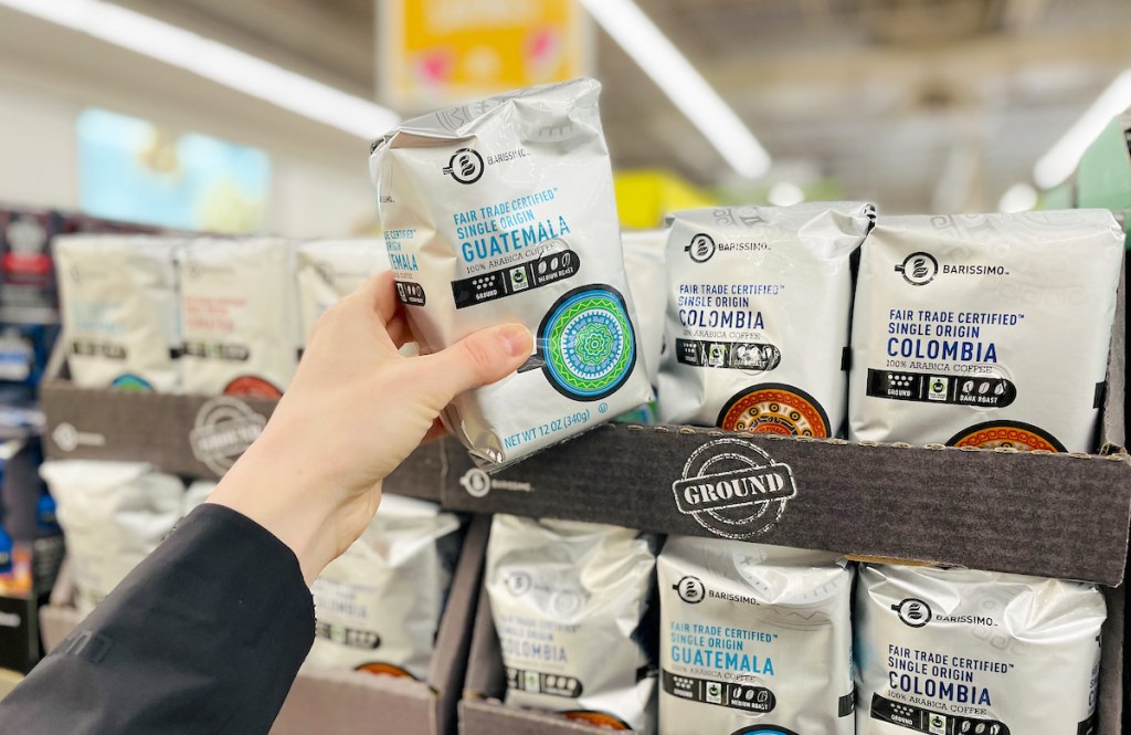 hand holding package of fair trade ground coffee