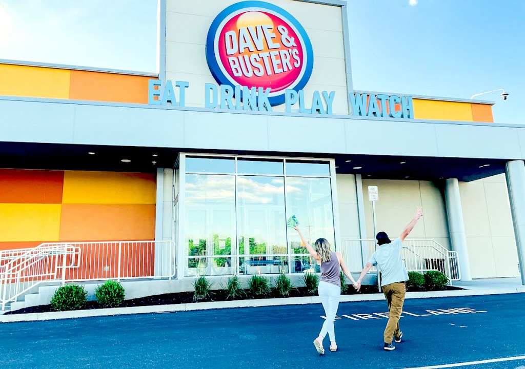 couple walking into dave and busters storefront