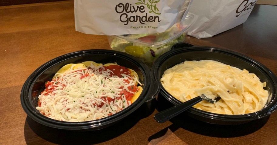 two pasta meals sitting by each other on a table