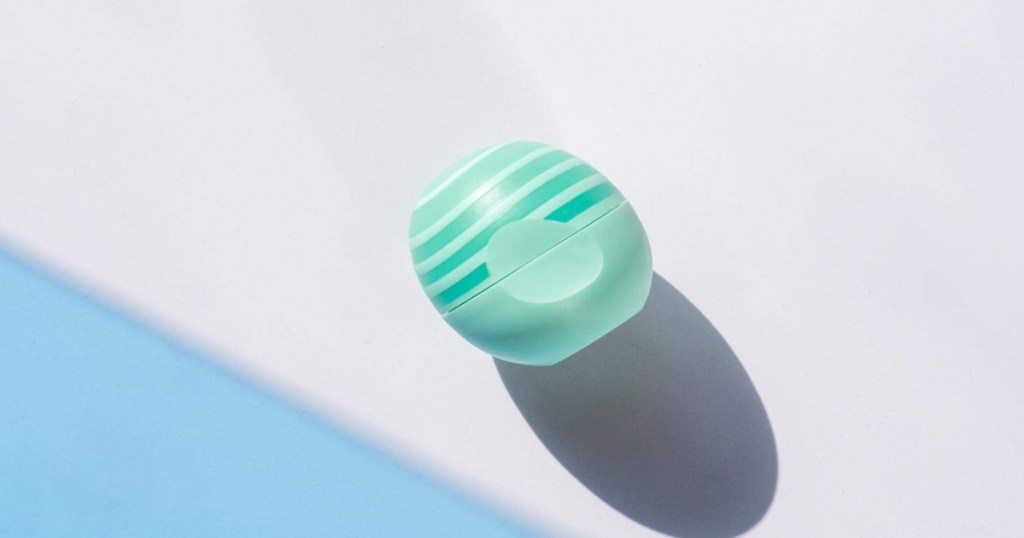 eos aloe lip balm with closed lid. It is a light green color with darker green stripes on top