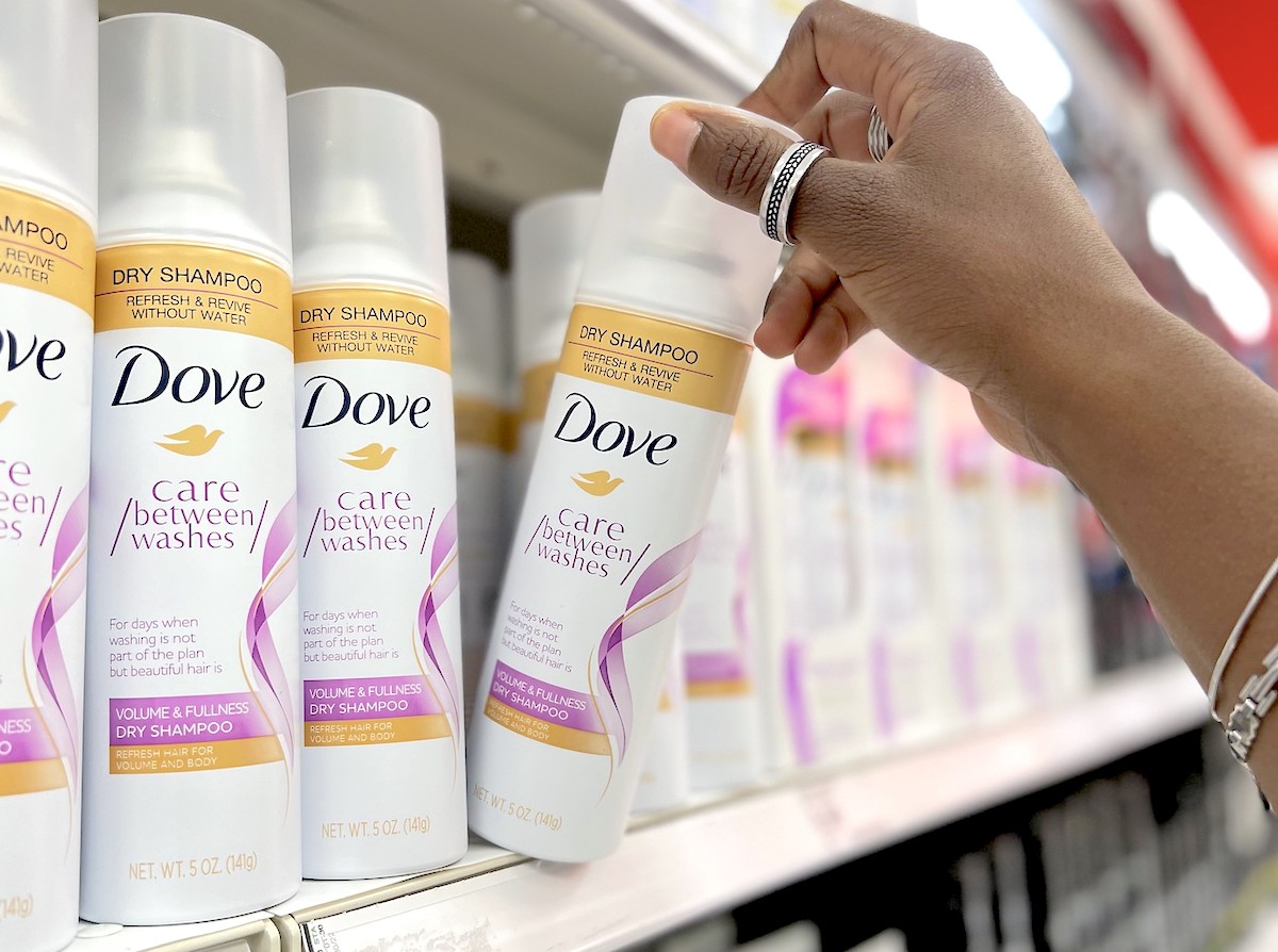 hand taking dove between wash spray off store shelf