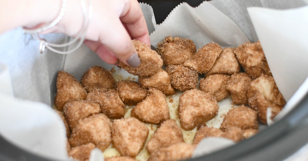 placing monkey bread dough into crockpot