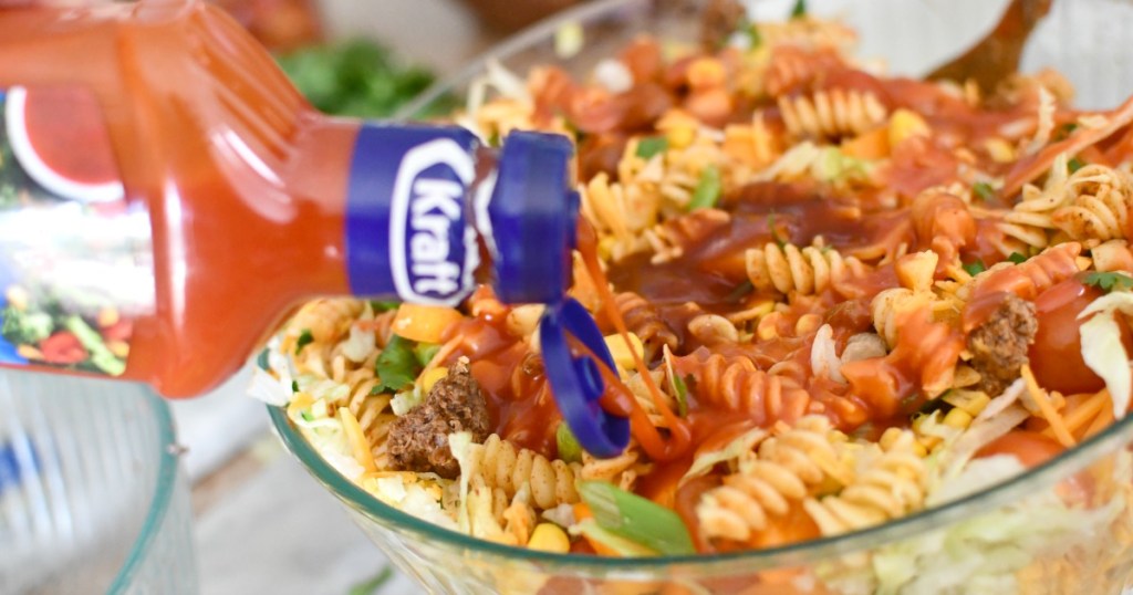 adding salad dressing to taco salad
