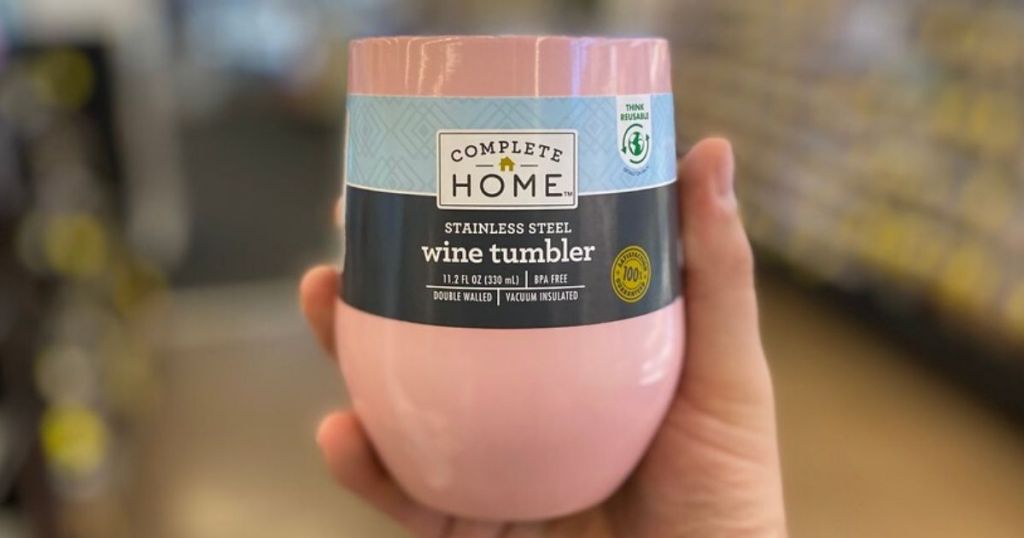man's hand holding a stainless steel wine tumbler