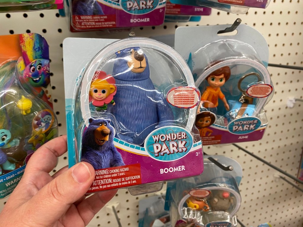 hand holding wonder park toy with blue bear and flower