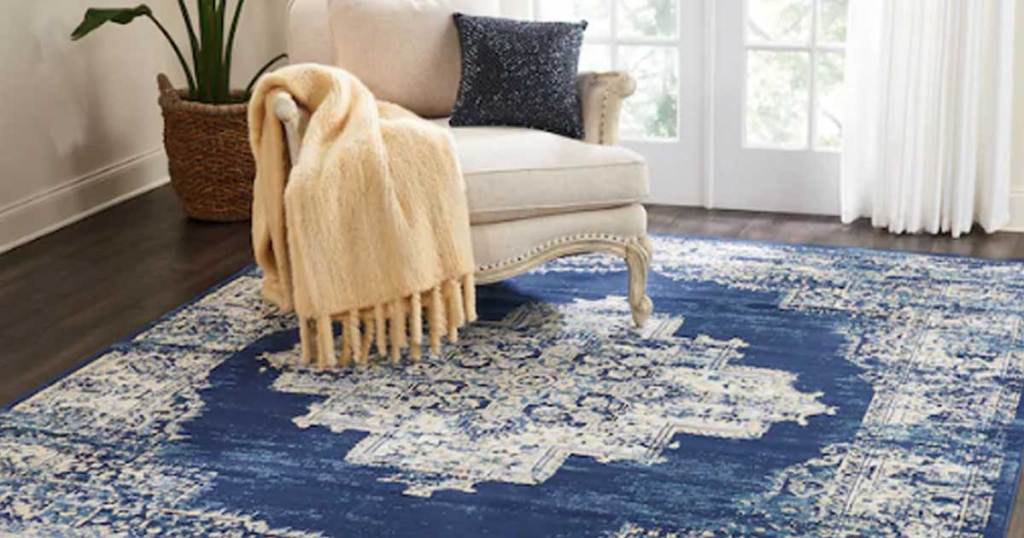 blue area rug in a living room with a chair on it