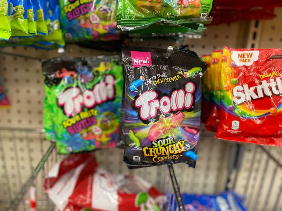 bags of candy hanging on pegs at store