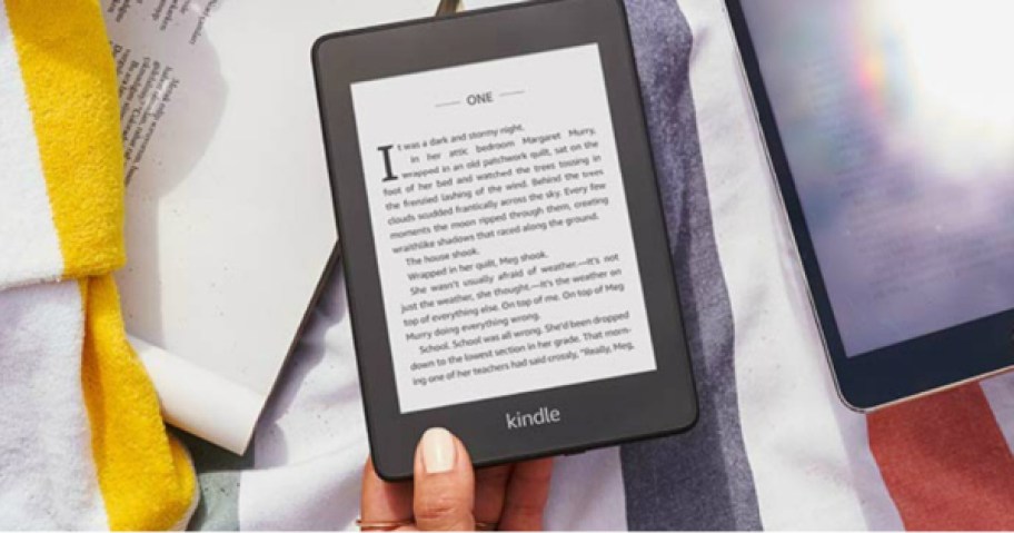 amazon kindle in hand on towel