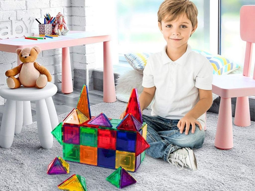 boy playing with Picasso Tiles in bedroom
