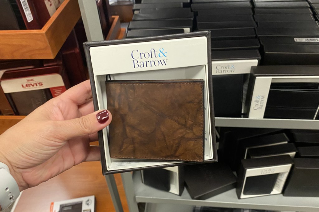 hand holding a brown wallet at kohl's