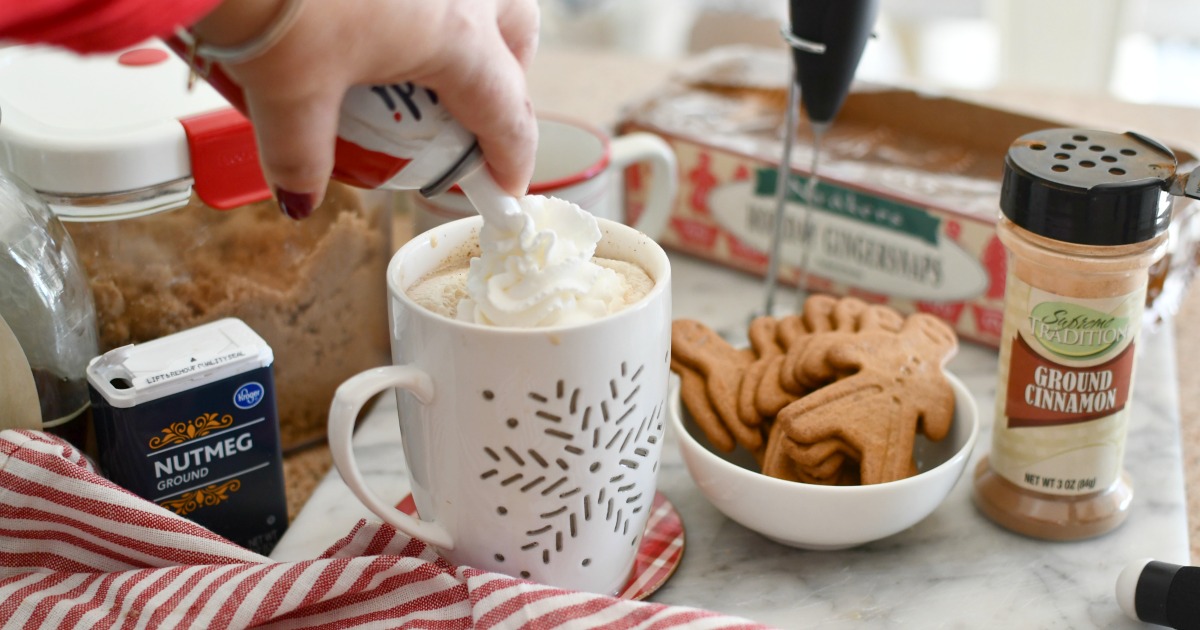 adding whipped cream to latte