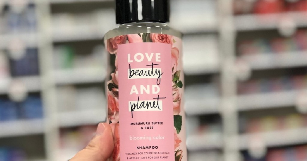 holding shampoo at store