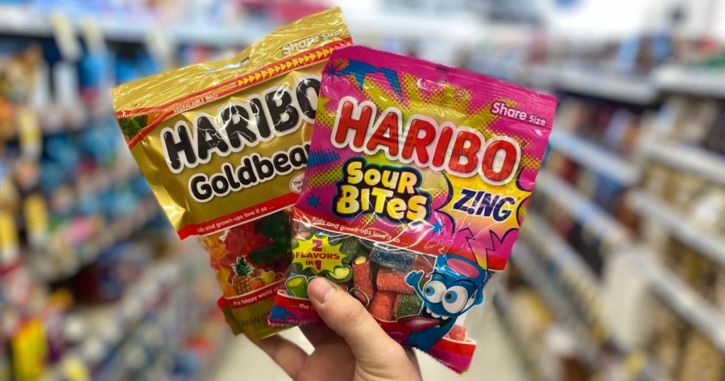 hand holding gummy bears and worms 